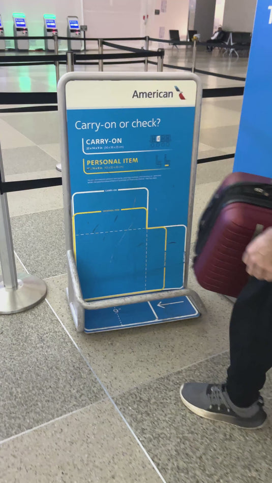 Demonstration of the Travhalór wearable suitcase jacket: packing clothes into hidden vacuum compression pockets to replace a carry-on, then converting the jacket into a travel backpack to avoid airline baggage fees.